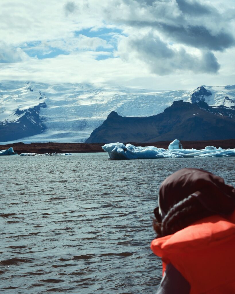 A person looking at a glacier and mountain in Iceland