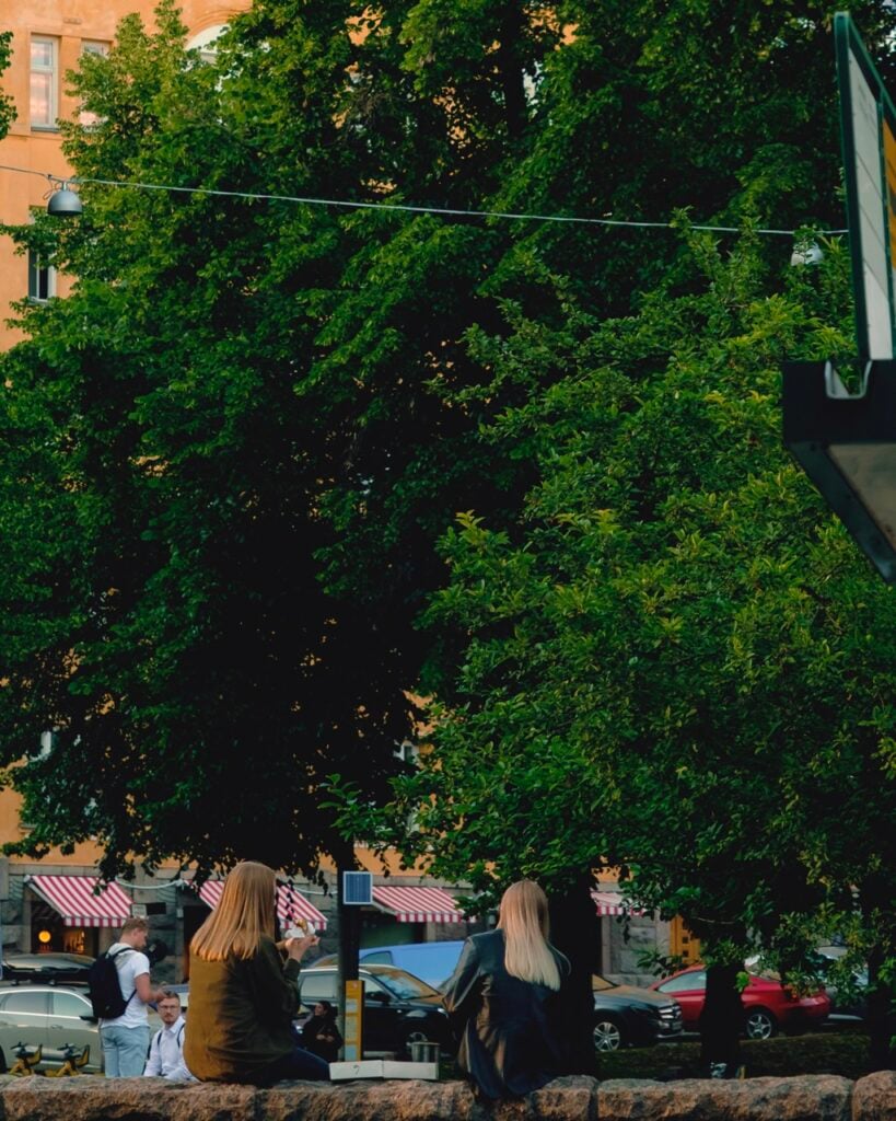 Two friends eating pizza in Kallio, Helsinki