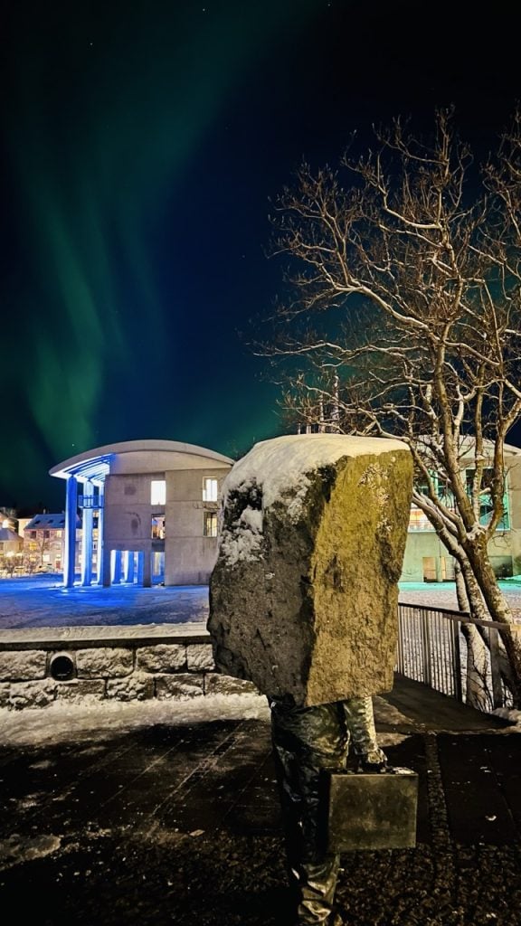 Northern Lights on a statue in Iceland