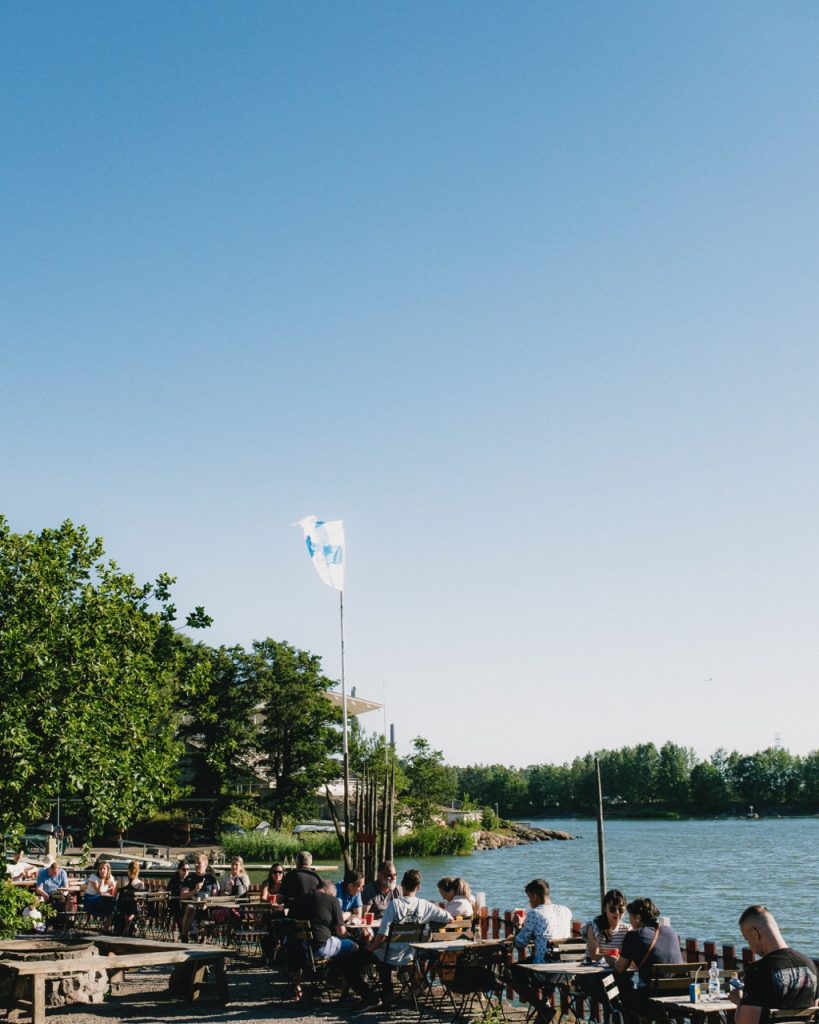 People sitting outside Cafe Regatta in Helsinki during the summer