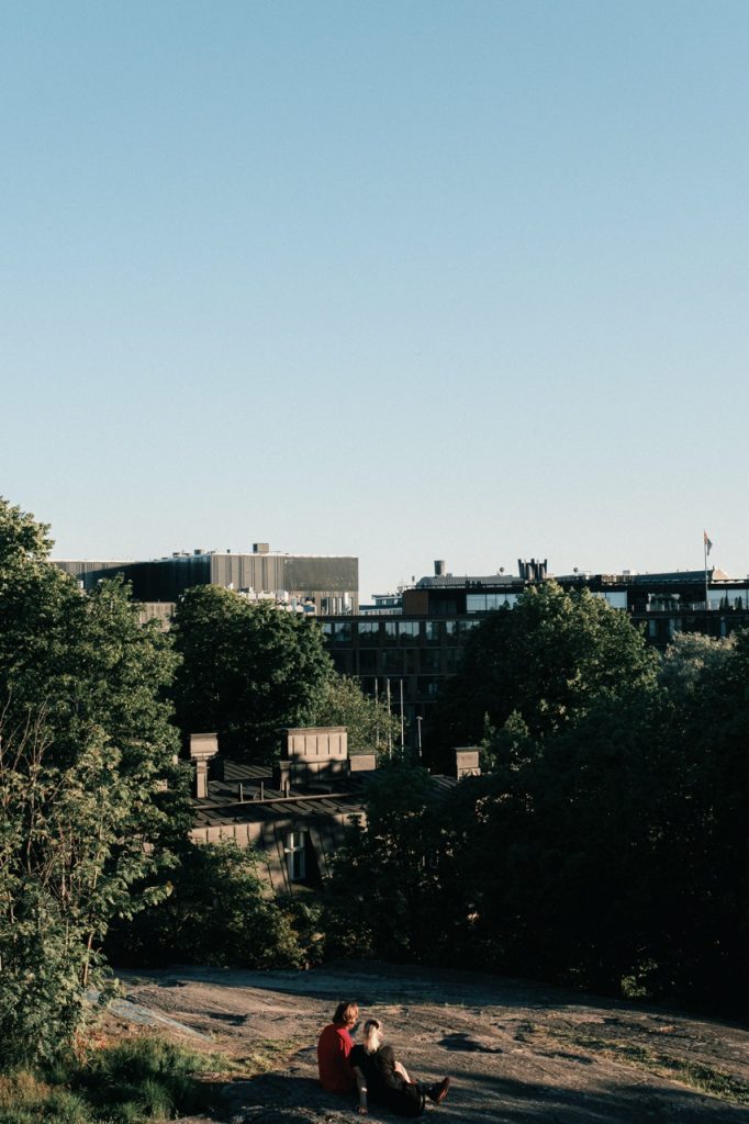 Photo of people sitting on a rock in Helsinki