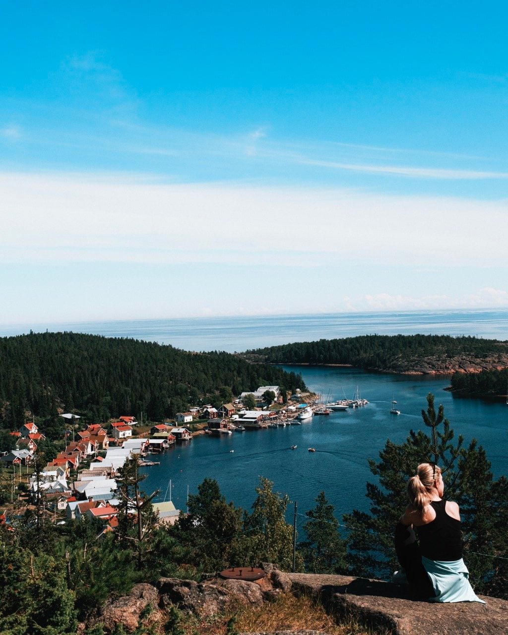 View of Ulvön from Lotsberget with a woman sitting in the picture