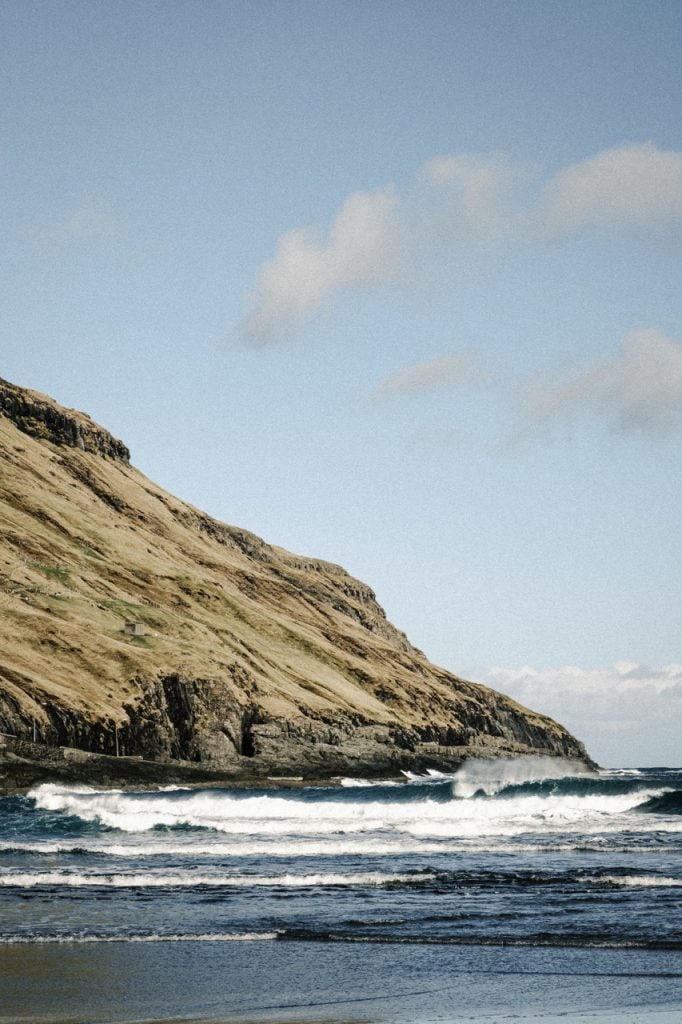 photo of a beach and mountain on the sea in the faroe islands