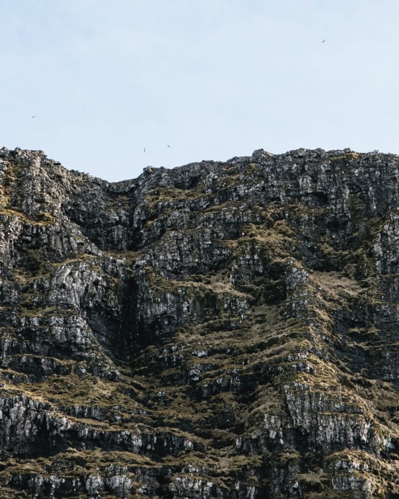 Photo of mountains and birds in the Faroe Islands