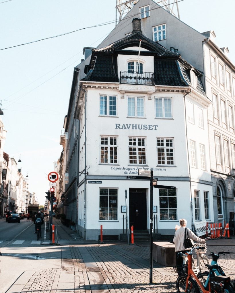 A woman walking her bike in Copenhagen