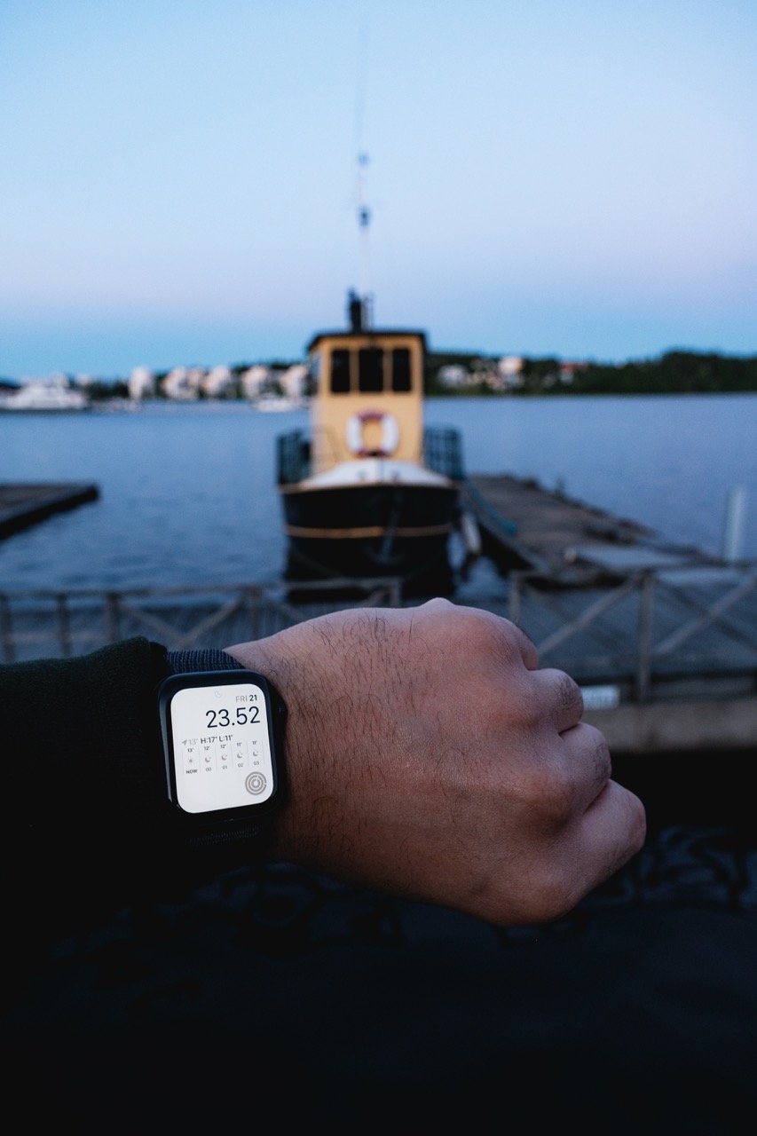 A photo of a man's Apple Watch showing the time and summer brightness while walking in Jyväskylä, Finland