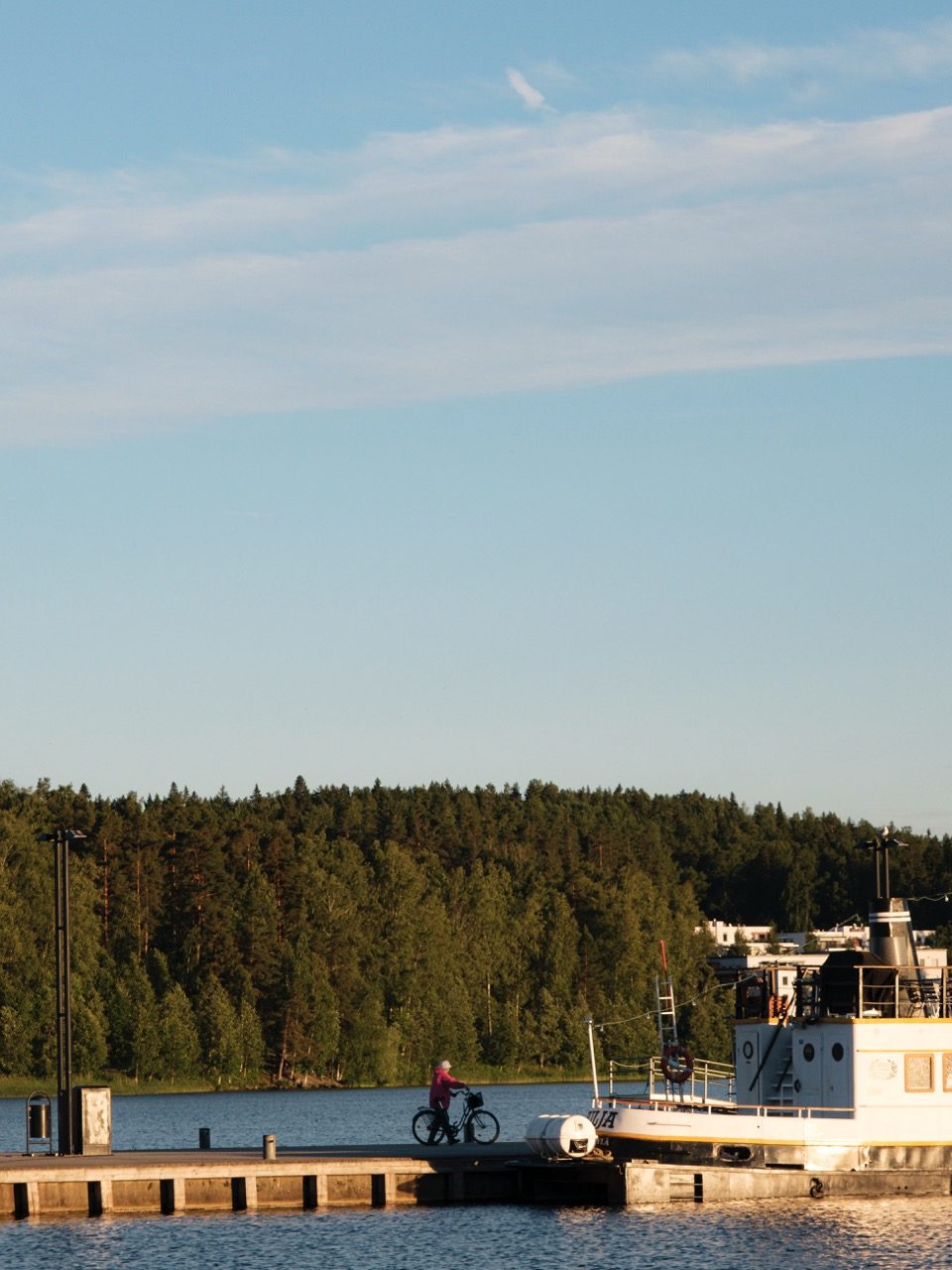 A person walking with their bike in Jyväskylä, Finland