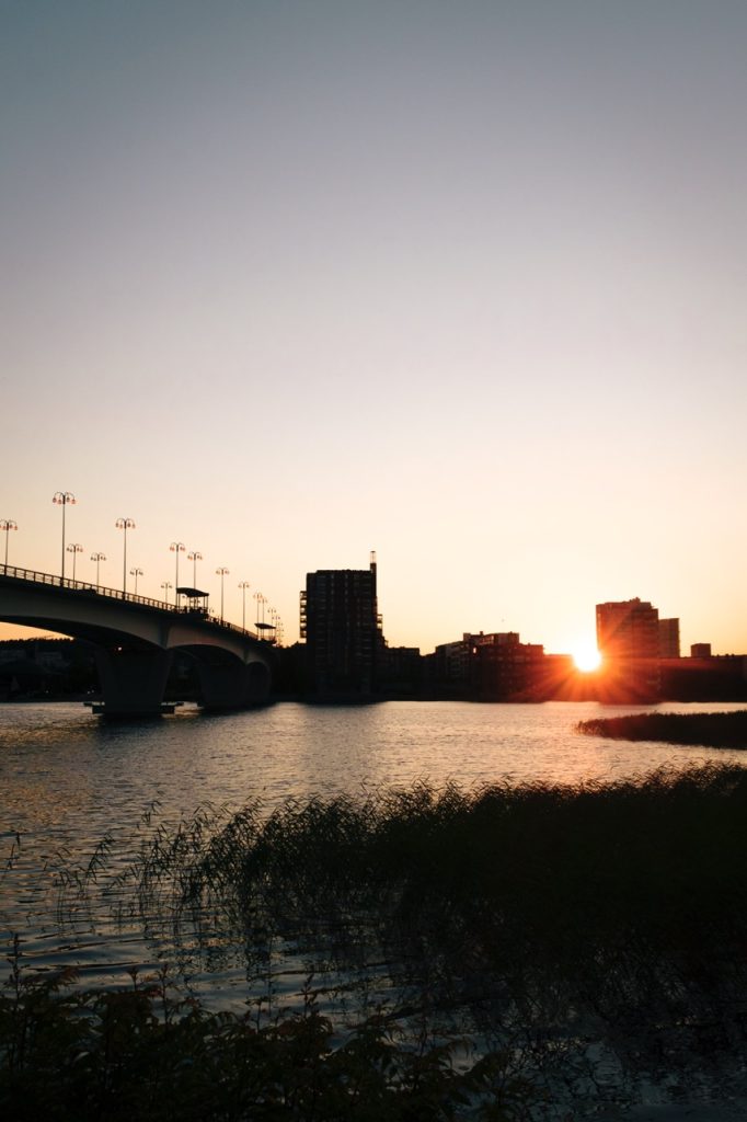 A photo showing lens flare as the sun is going down on a midsummer day in Finland