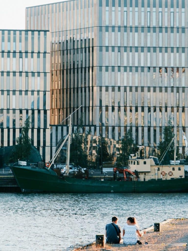 A couple sitting by the waterfront in Helsinki