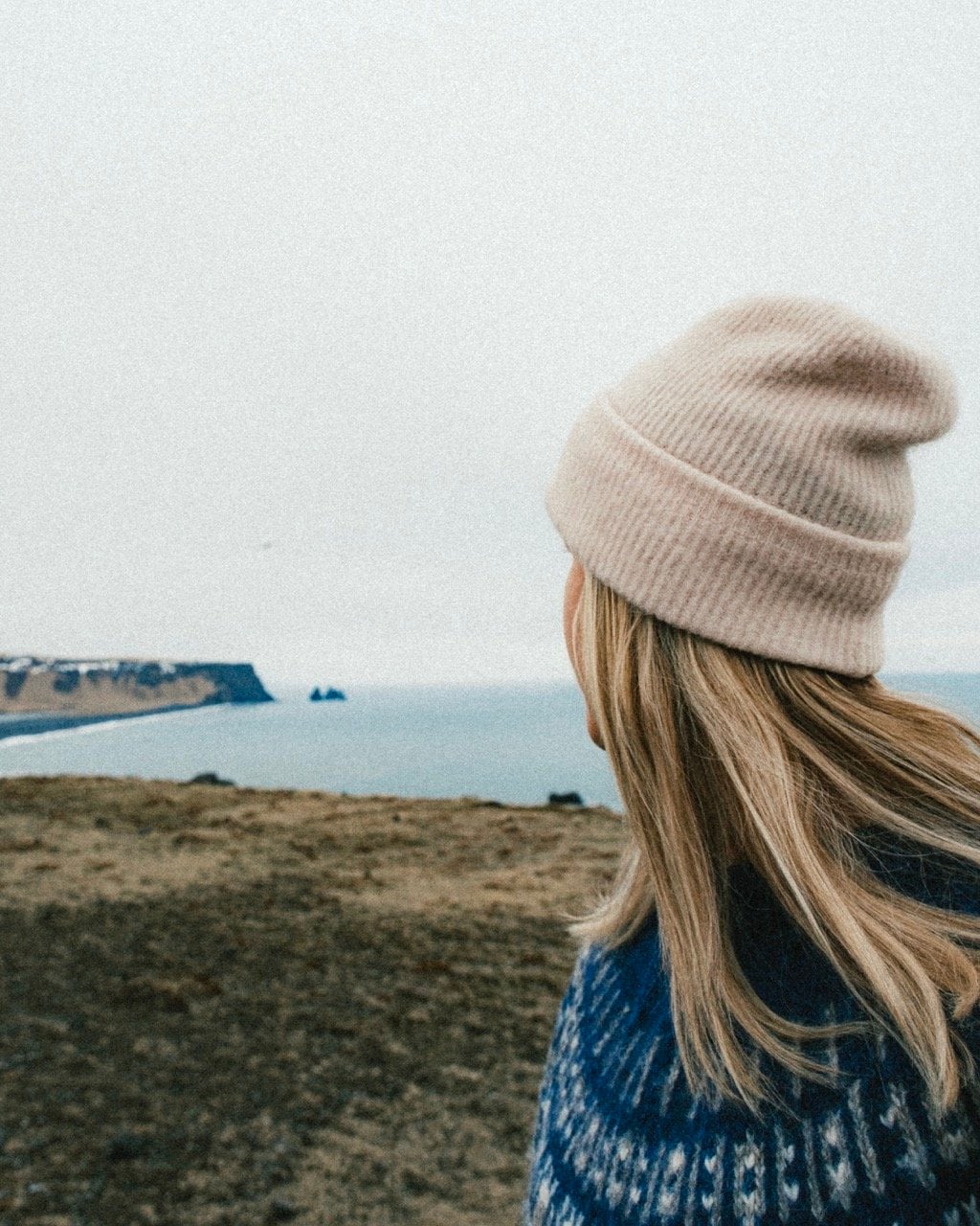 A person looking on at Dyrholaey in Iceland