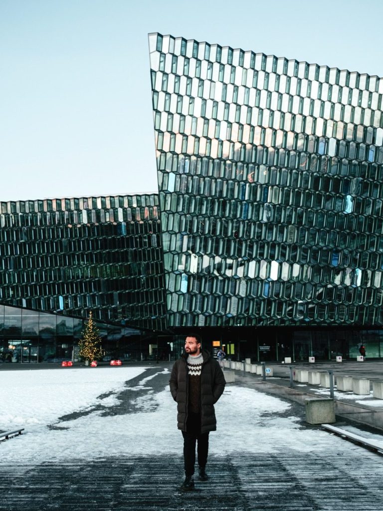 A person walking outside Harpa Concert Hall in Reykjavik