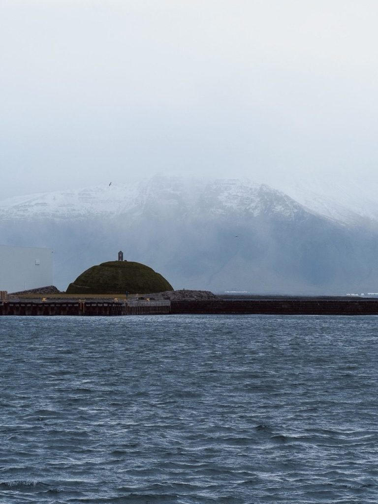 A photo of clouds covering a mountain in Reykjavik