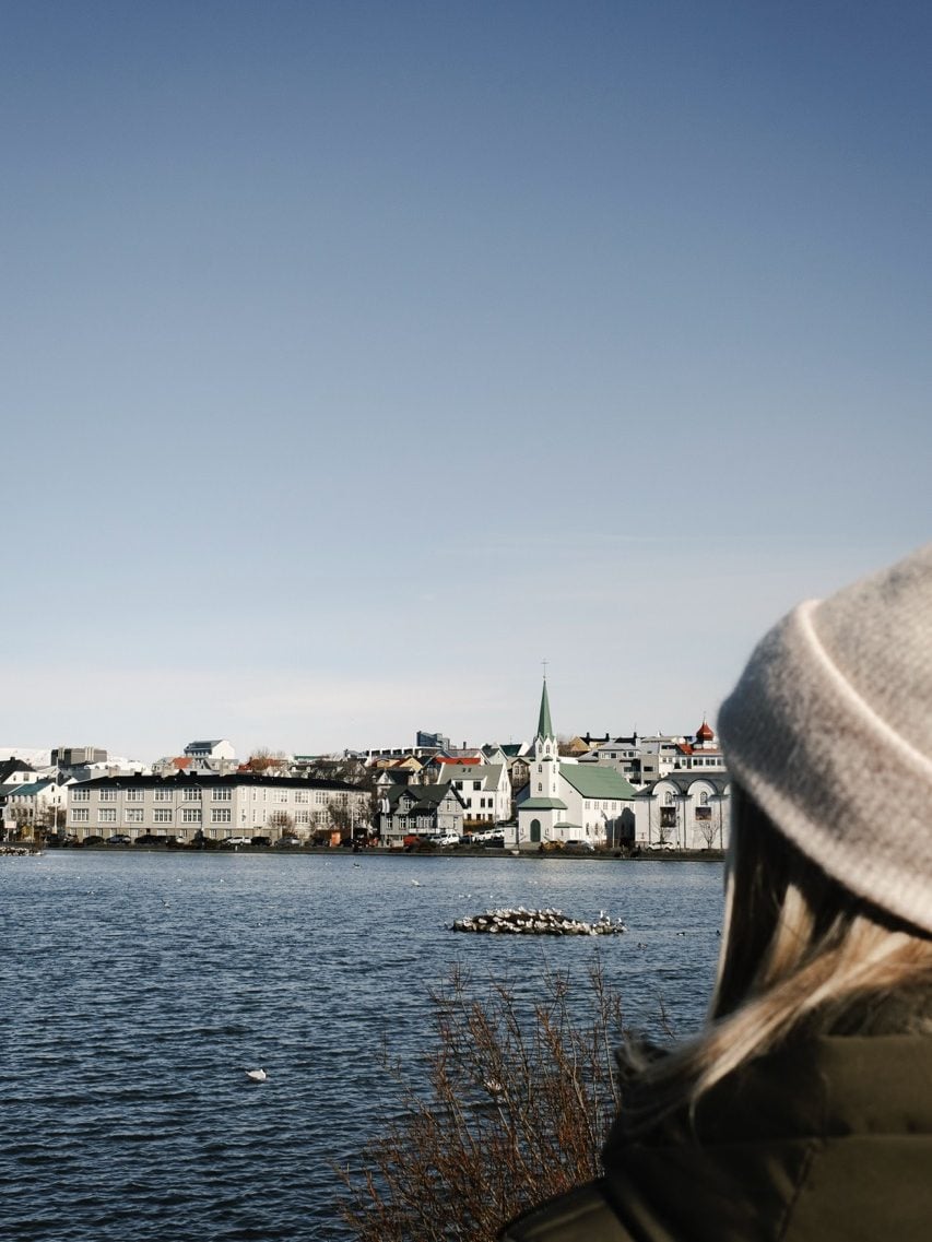 A person looking at the scenery at Tjörnin, Reykjavík