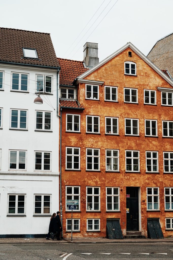 People walking past a building in Indre By, Copenhagen