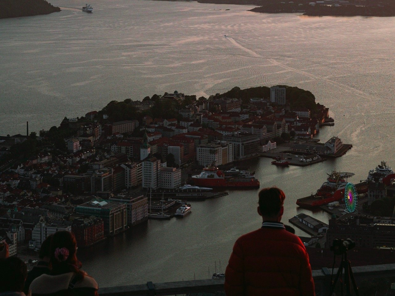 A person taking photos from the viewpoint in Fløyen, Bergen