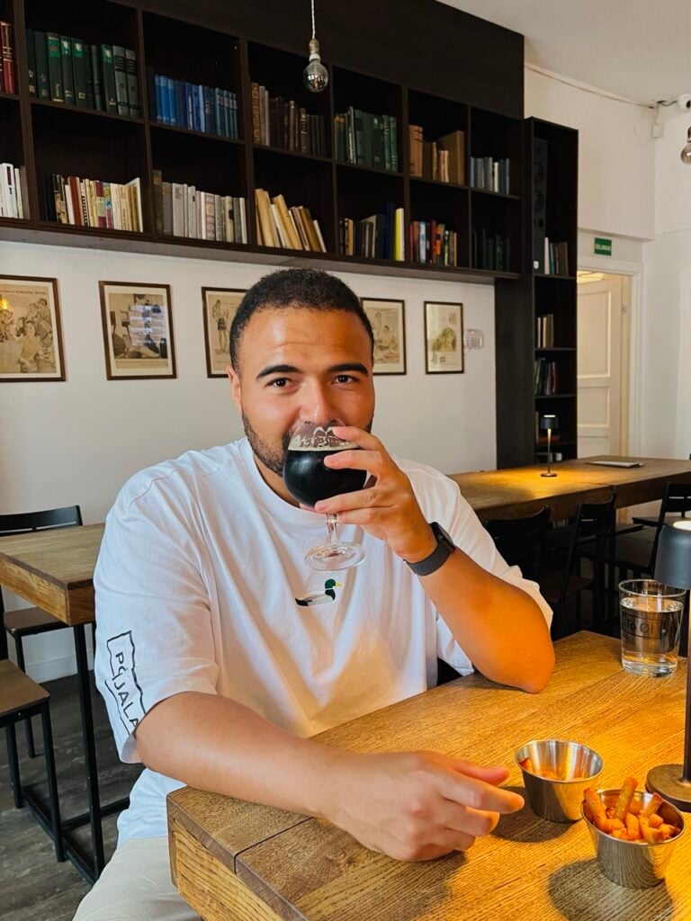 A man drinking beer at Alaus Biblioteka in Vilnius, Lithuania