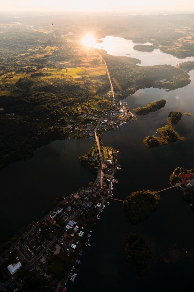 A hot air balloon flying over Lithuania on a summer evening