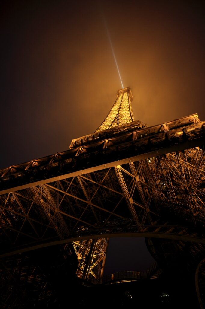 The bottom of the Eiffel Tower in Paris, France, at night