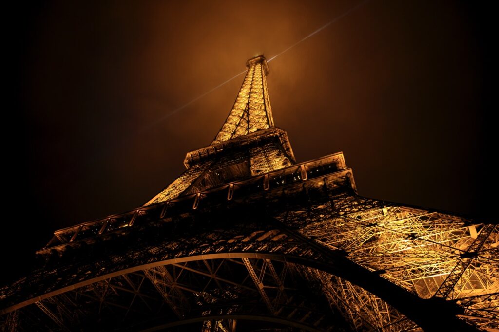 The Eiffel Tower at night, as seen from the bottom of the building
