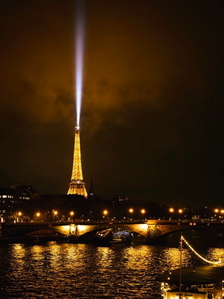 The beam of the Eiffel Tower at night