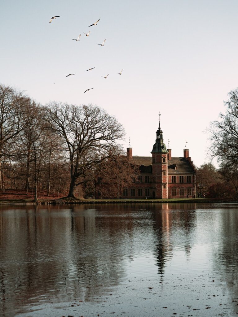 Birds flying over part of the gardens at Frederiksborg Slot in Hillerød