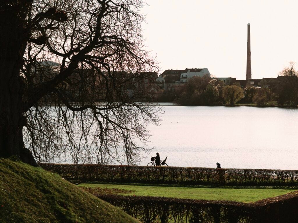 Person walking bike outside Frederiksborg Castle