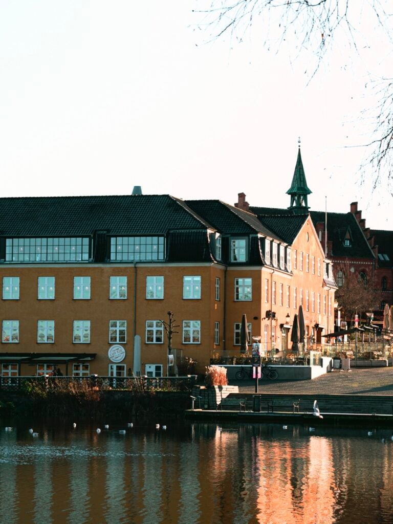 Buildings on the other side of a lake in Hillerød, Denmark