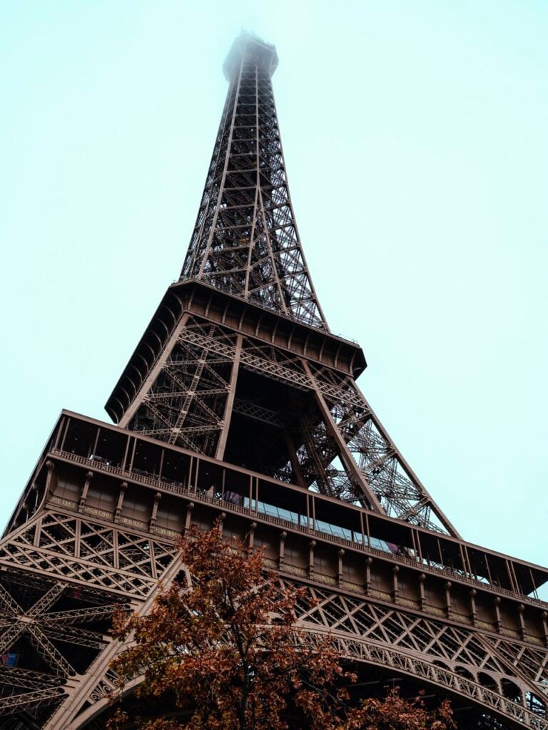A close-up of the Eiffel Tower on a cloudy day