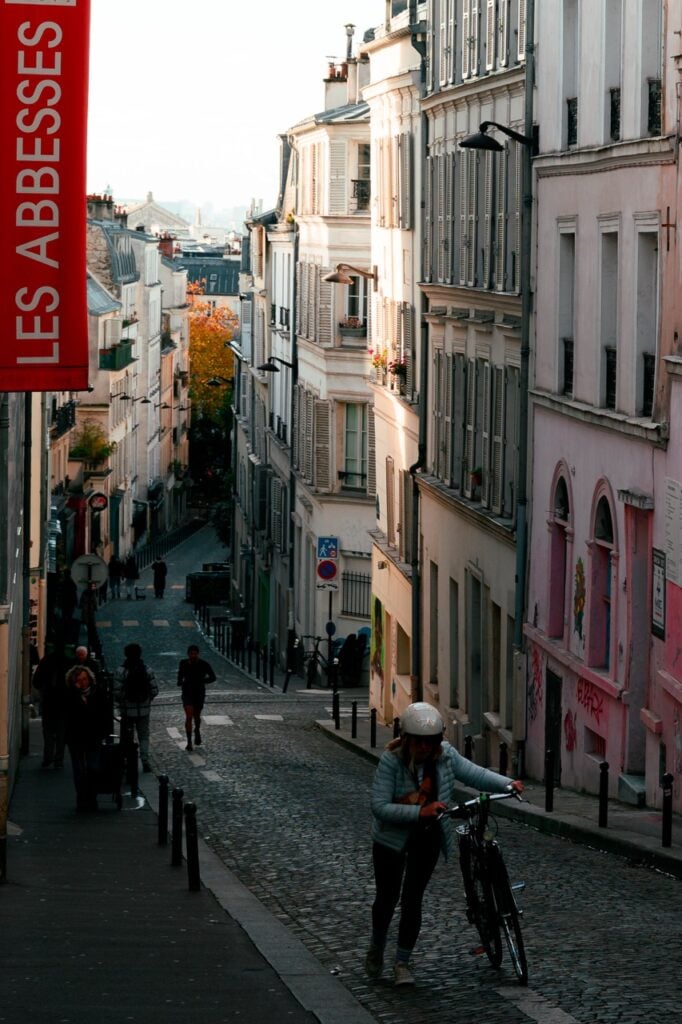 A person walking their bike in Montmartre, Paris