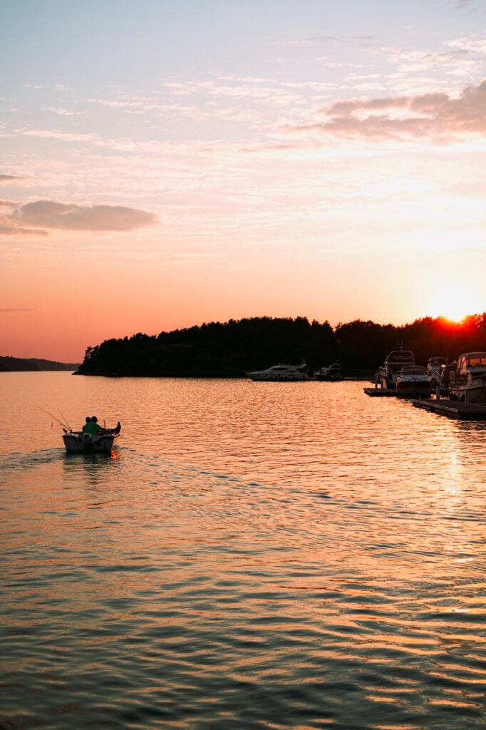 Two men on a boat at sunset in Naantali, Finland