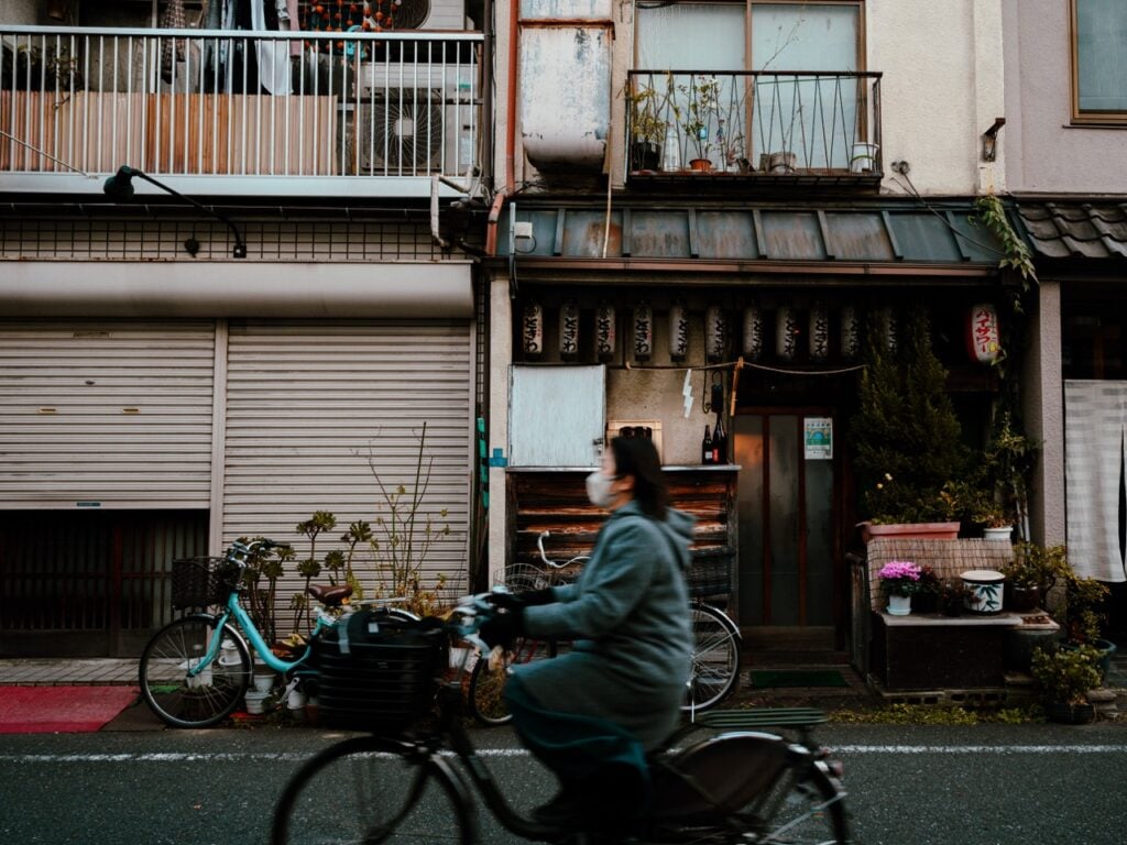 A woman cycling in Tokyo, Japan