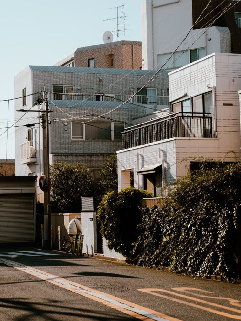 A person cycling down a street in Tokyo, Japan