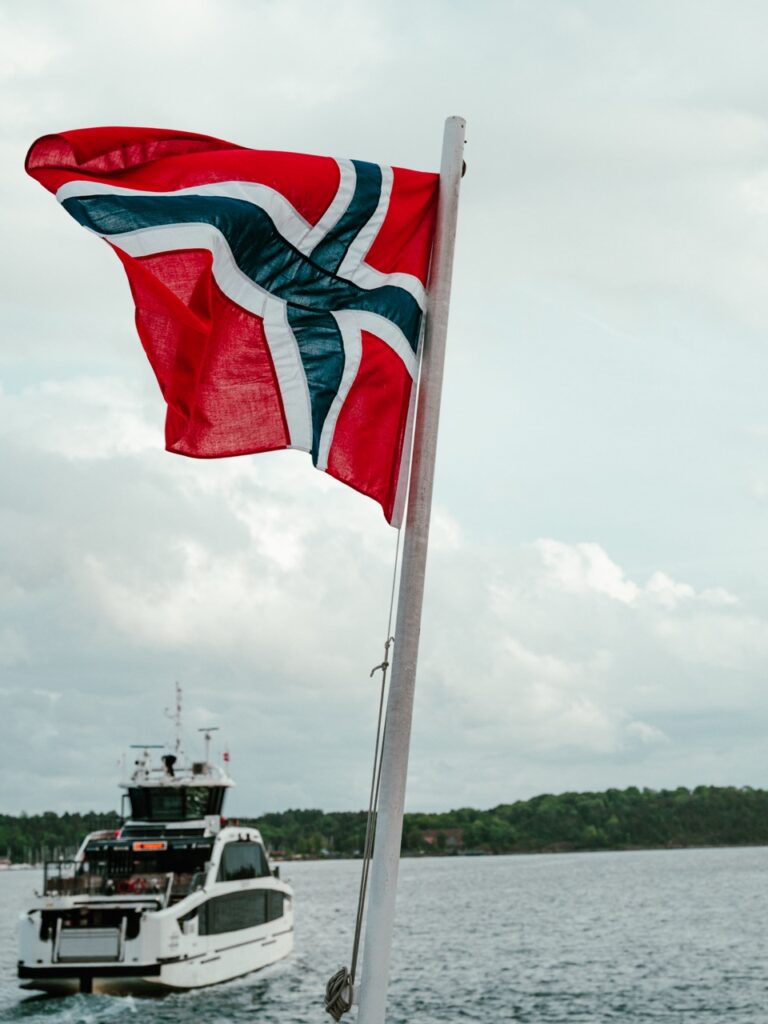 A ferry and Norwegian flag in Oslo