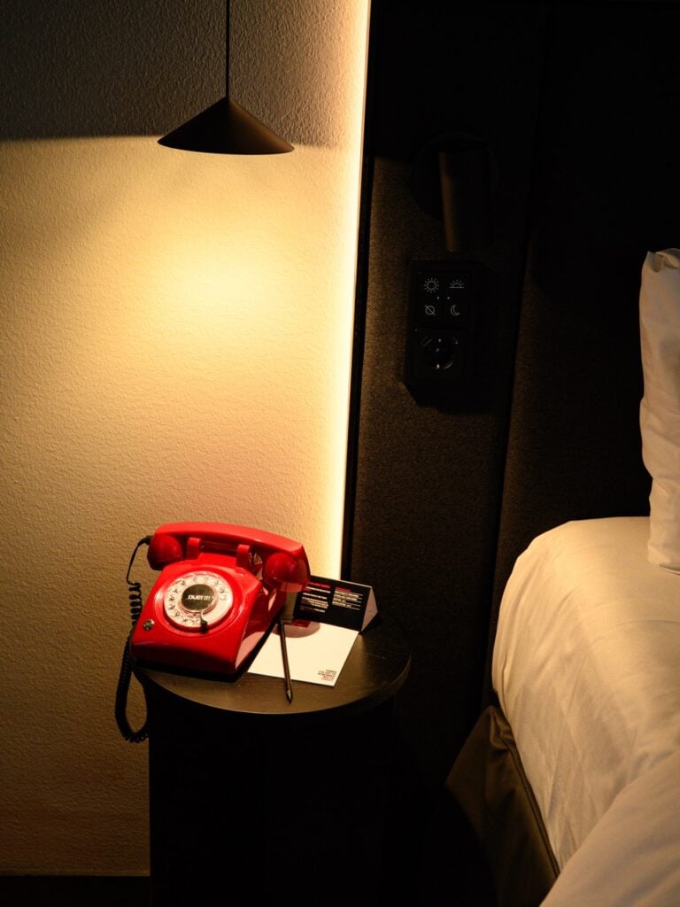 The phone next to a bed in Radisson RED in Helsinki, Finland