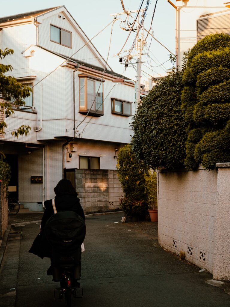 A woman cycling in Tokyo, Japan, during the evening
