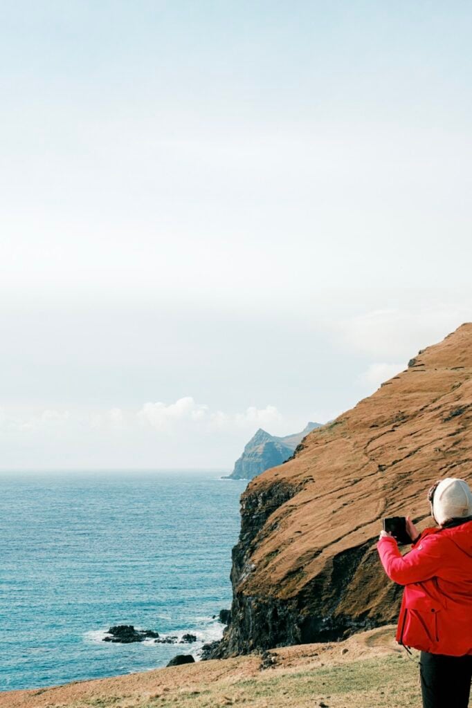 A tour guide in the Faroe Islands taking photos