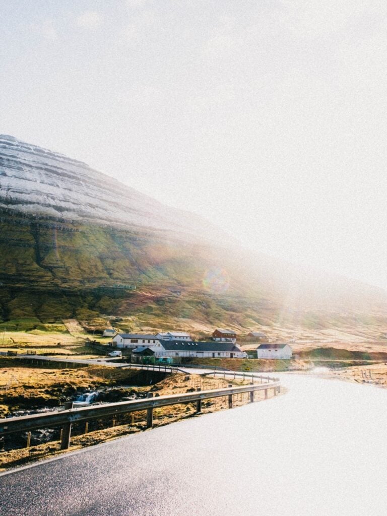 Driving in the faroe islands on a day of sun and rain
