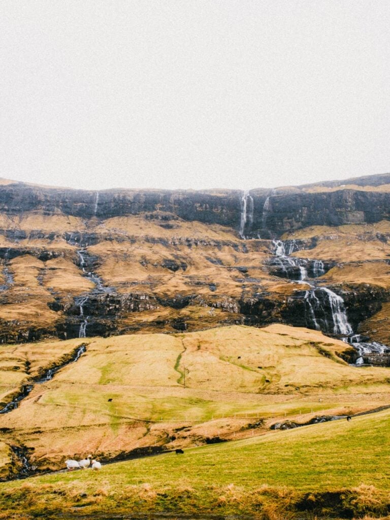 A view of a waterfall in the Faroe Islands from below