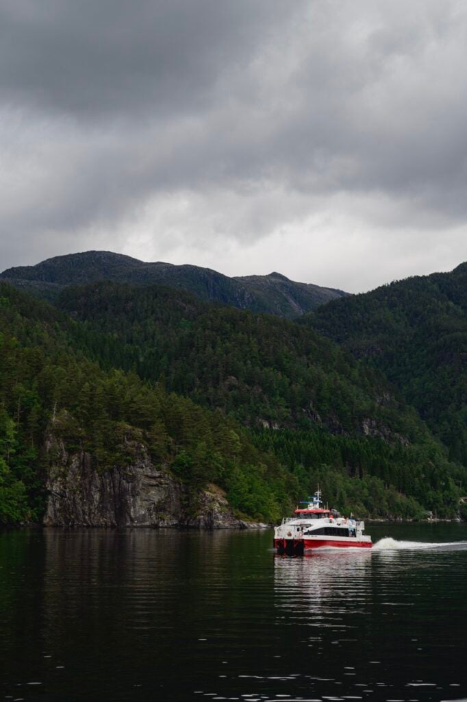 A boat cruising along a fjord near Bergen, Norway