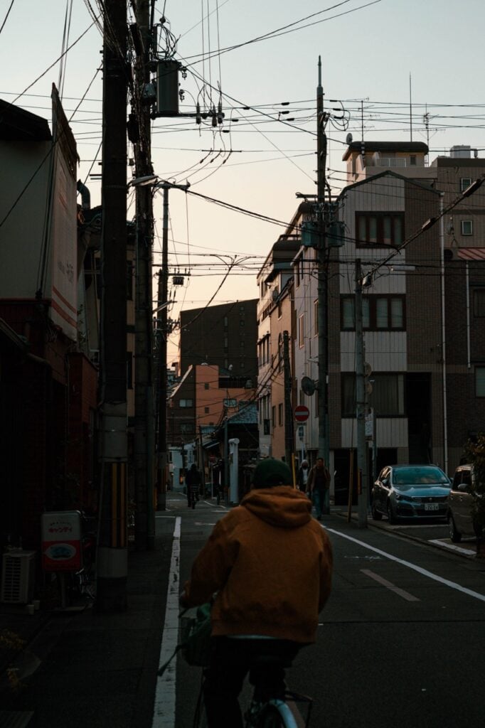A person cycling in Kyoto, Japan, during Golden Hour