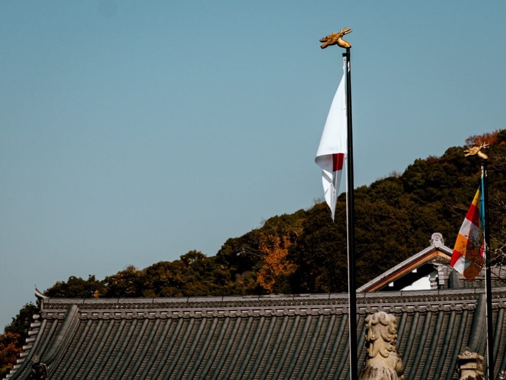 A temple with a Japanese flag in Kyoto, Japan