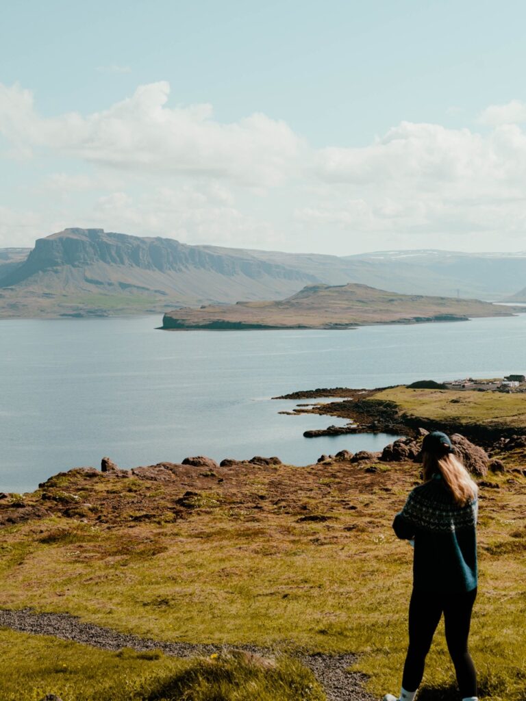 A woman walking at Hvalfjördur in Iceland
