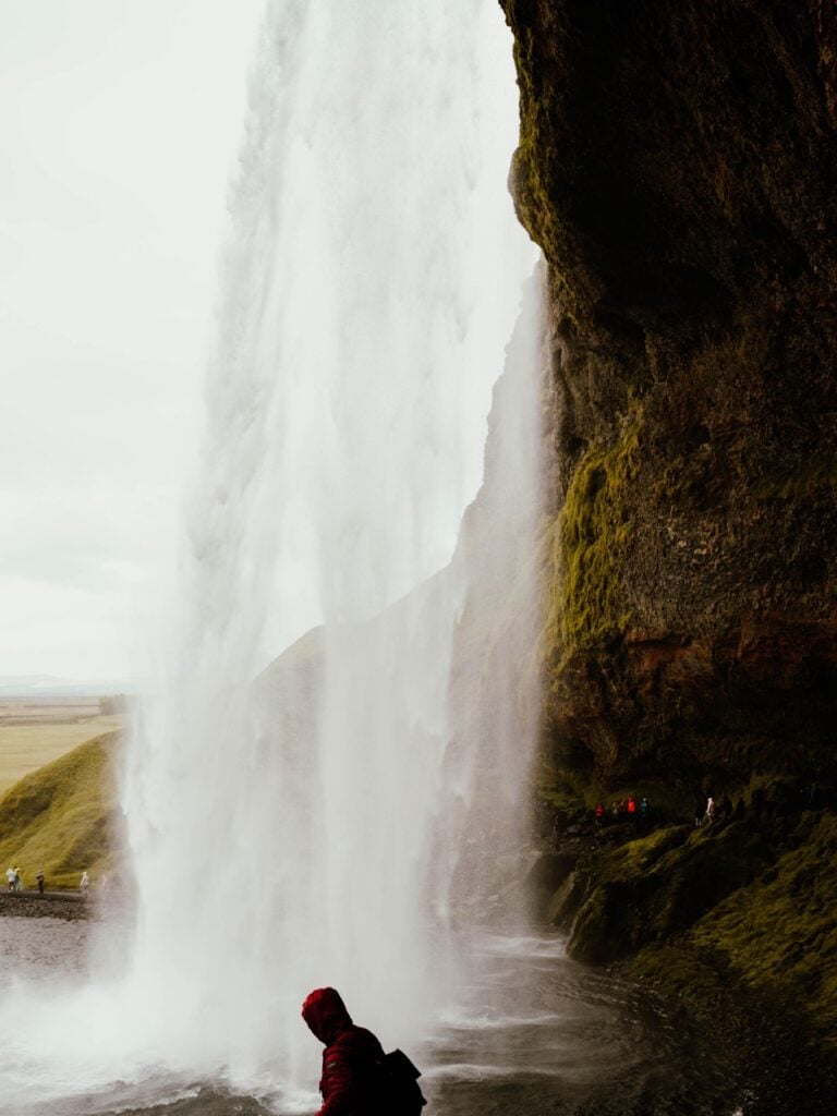 Danny Maiorca behind the waterfall in Seljalandsfoss