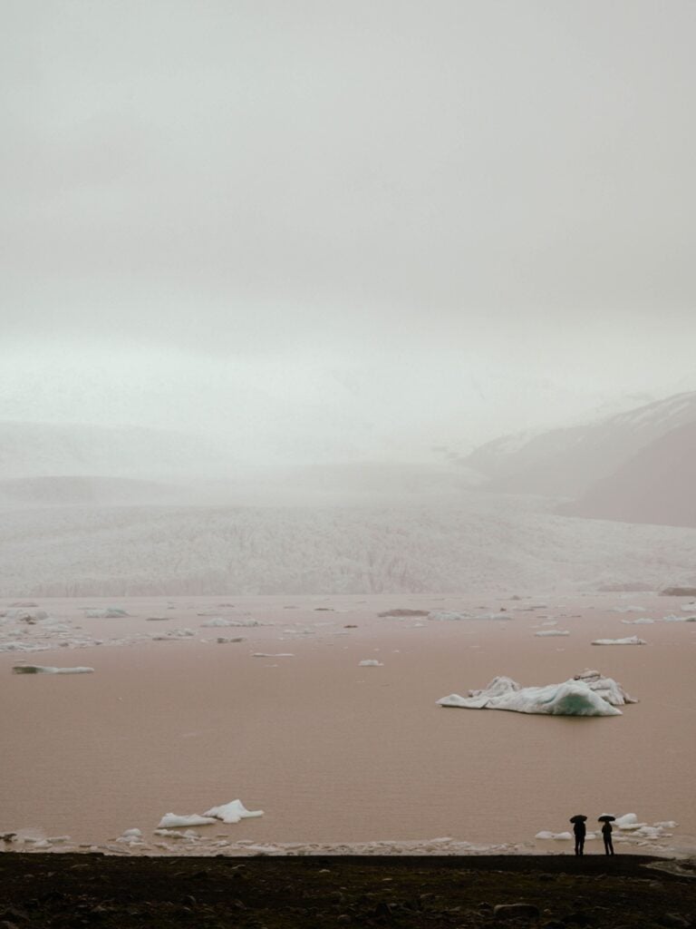 People standing at Fjallsárlón, Iceland