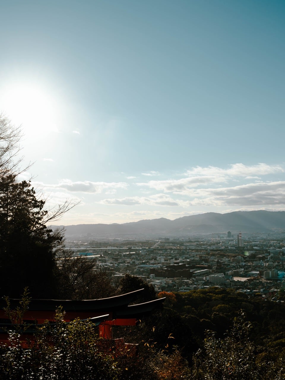 A view of kyoto with lens flare from the Fushimi Inari Shrine