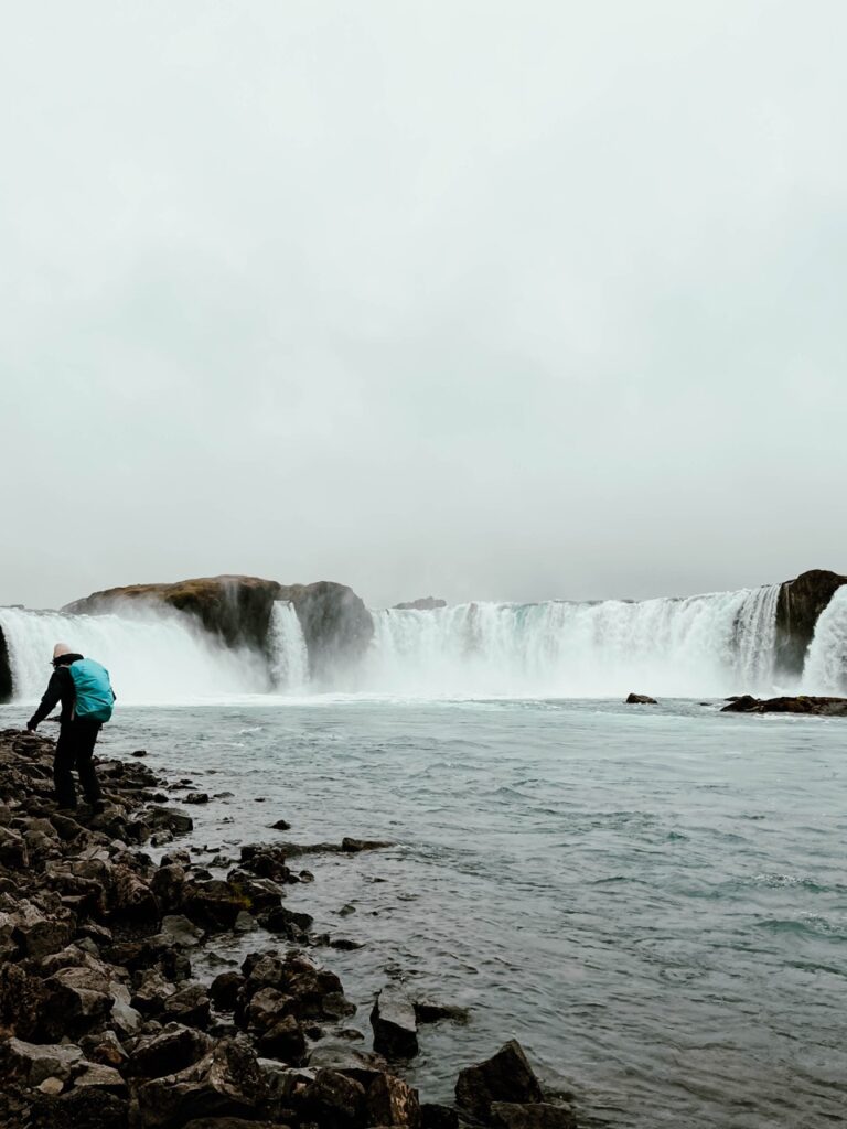 Person walking at Godafoss in Iceland
