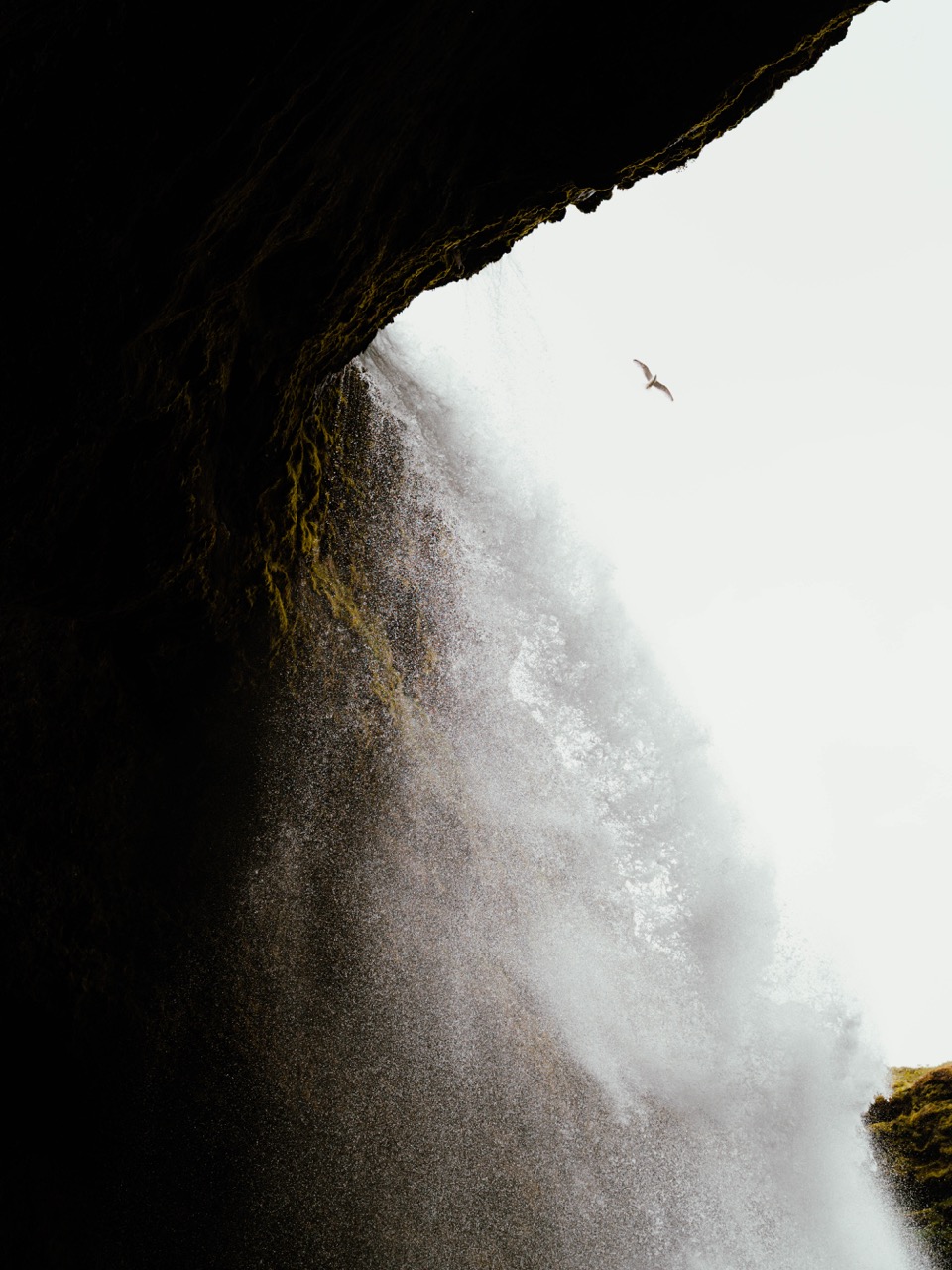under the kvernufoss waterfall in iceland