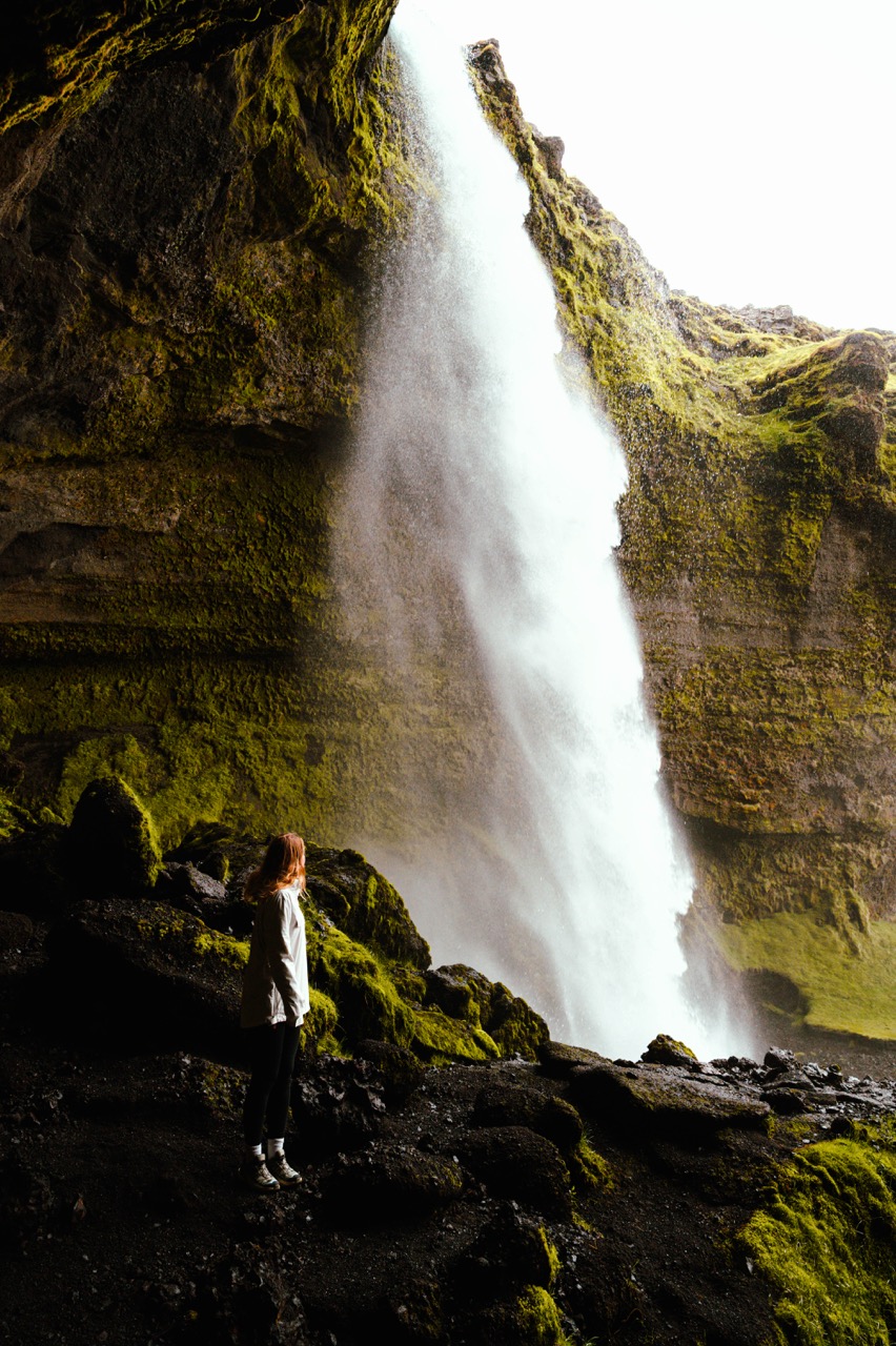 A person looking at the Kvernufoss waterfall in Iceland