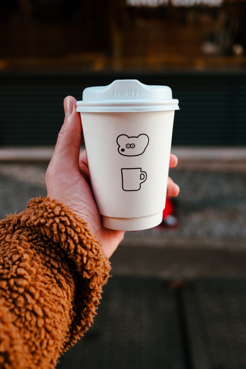 Holding a cup from Andy's Coffee in Tokyo