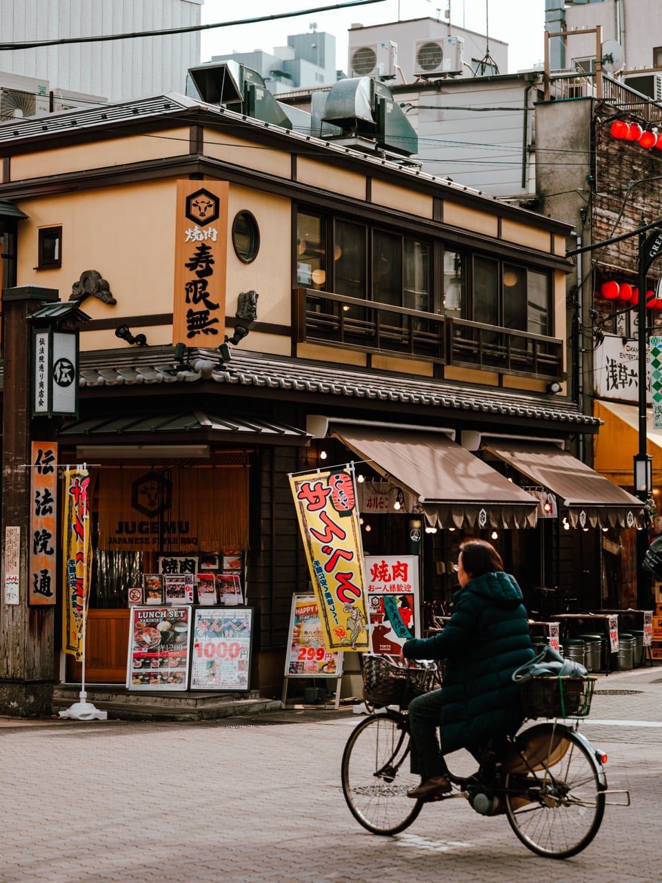 A person cycling in Asakusa, Tokyo, around lunchtime